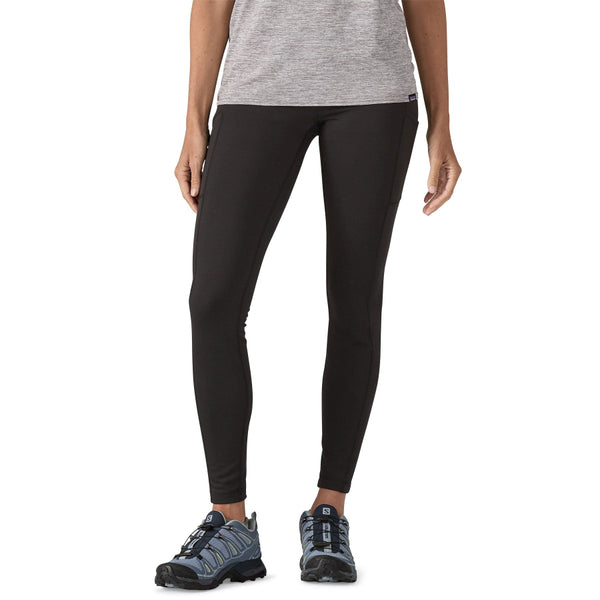Person wearing black Patagonia Women's Pack Out Tights on a white background.