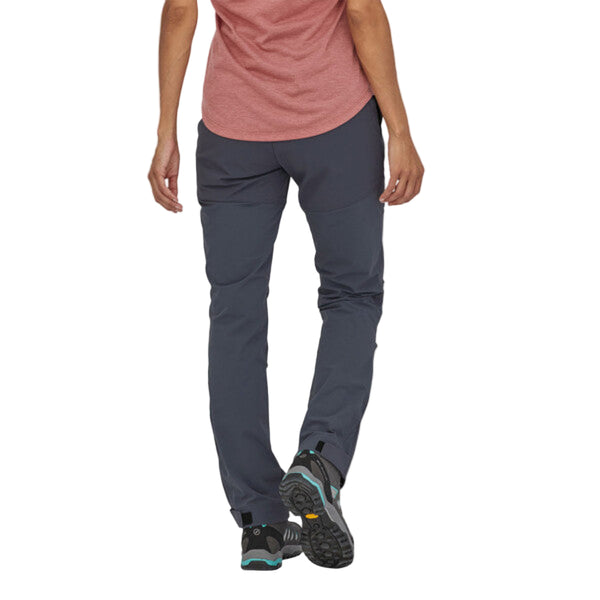 Person wearing the Patagonia Women's Point Peak Trail Pants in smolder blue on a white background.