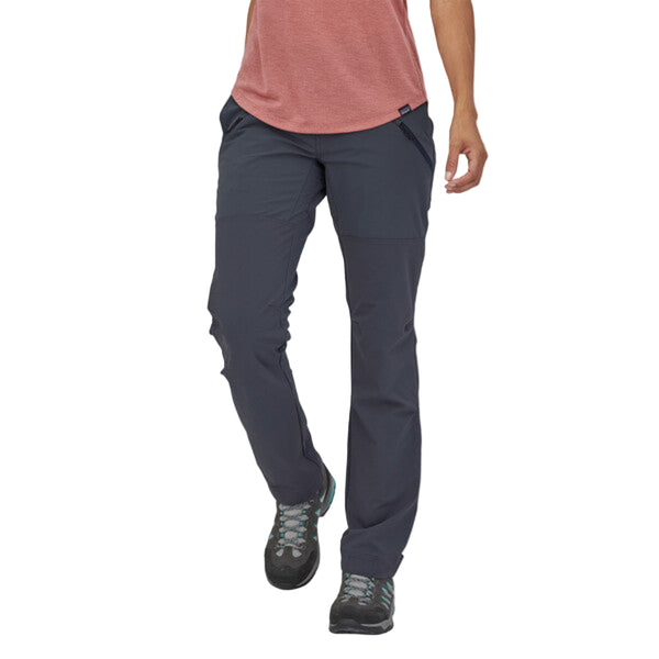 Person wearing the Patagonia Women's Point Peak Trail Pants in smolder blue on a white background.