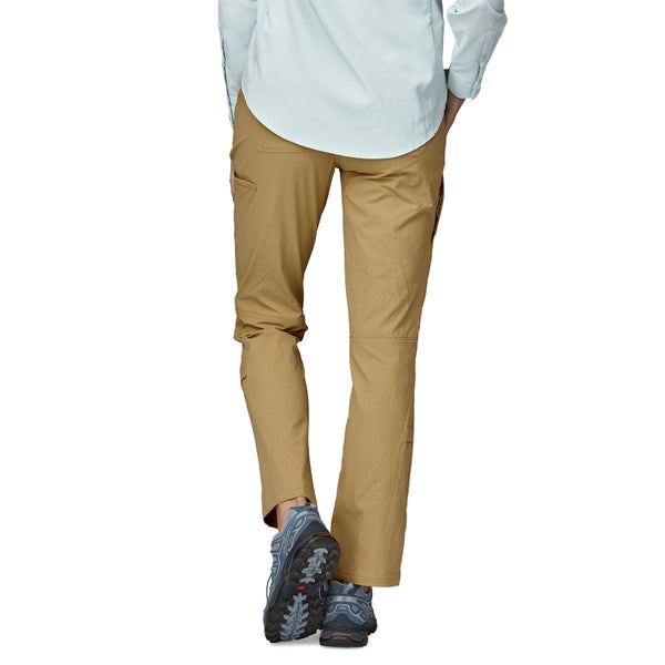 Person wearing the Classic Tan Patagonia Women's Quandary UPF Pants and a blue shirt on a white background.