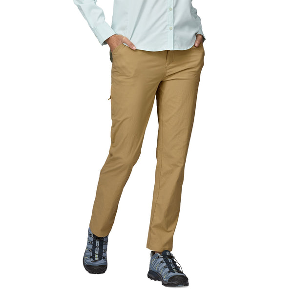 Person wearing the Classic Tan Patagonia Women's Quandary UPF Pants and a blue shirt on a white background.