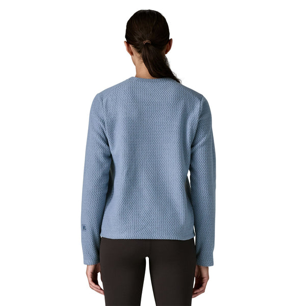 Woman wearing a Barnacle Blue Patagonia Women's R1 Air Fleece Crewneck Pullover on a white background.