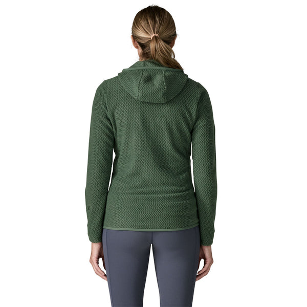 Person wearing blue leggings and the Patagonia Women's R1 Air Fleece Full-Zip Hoody in canopy green color shown from the back, against a white background.