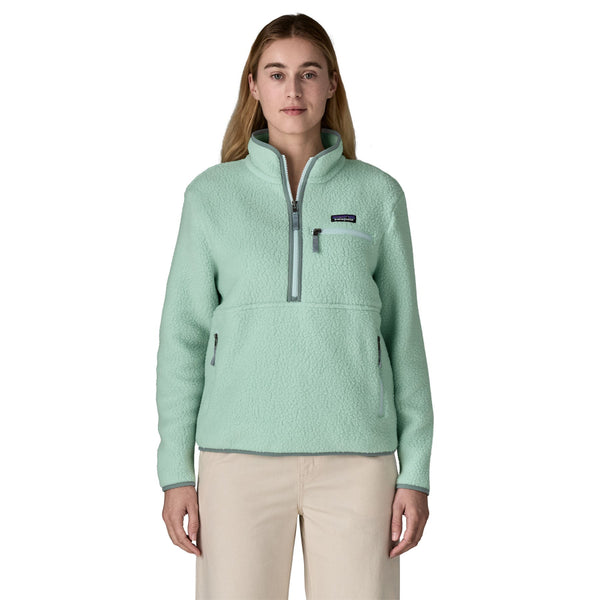 Person wearing a light green Patagonia Women's Retro Pile Marsupial Fleece pullover and tan pants on a white background.