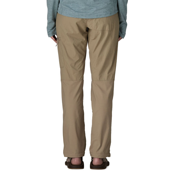 Person wearing seabird grey Patagonia Women's Sandy Cay Wading Pants and a blue top on a white background.