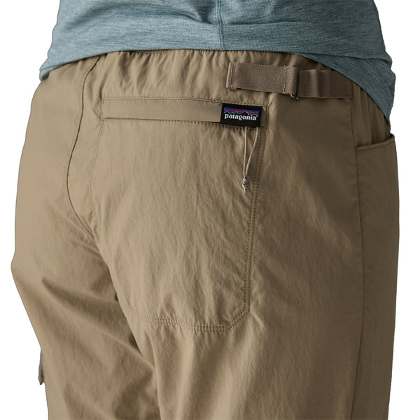 Person wearing seabird grey Patagonia Women's Sandy Cay Wading Pants, showing the back pocket details, on a white background.
