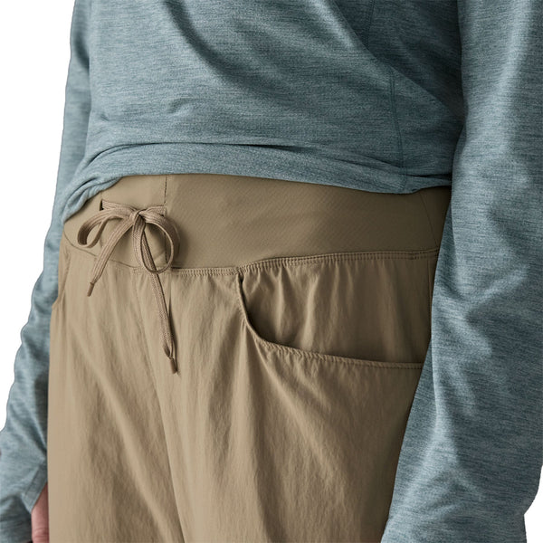 Person wearing seabird grey Patagonia Women's Sandy Cay Wading Pants, showing the waistband details, on a white background.