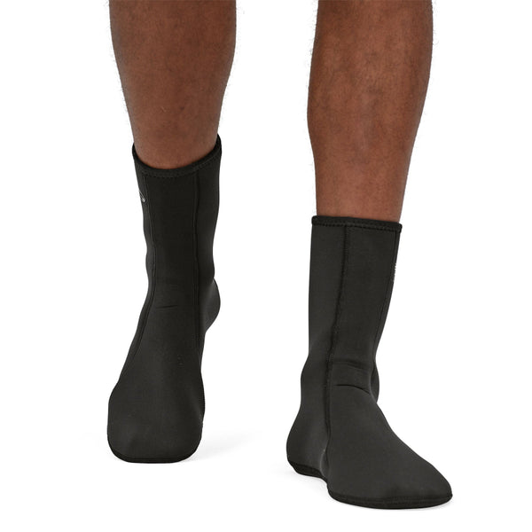 Person wearing black neoprene Patagonia Yulex Wading Socks on a white background.