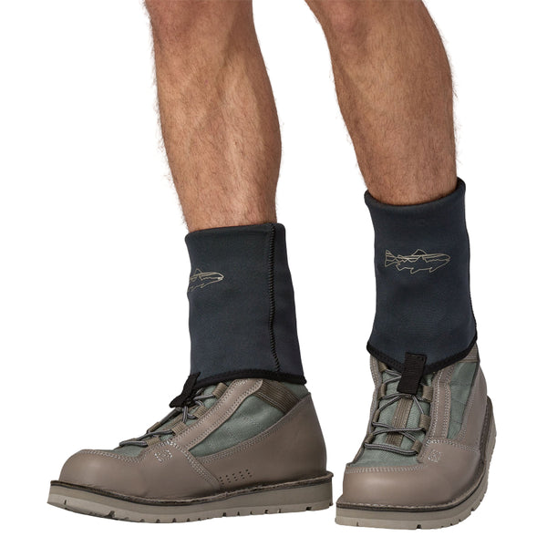 Person wearing black Patagonia Yulex Wading Socks showing the gravel guard details, worn over grey Patagonia River Salt boots on a white background.