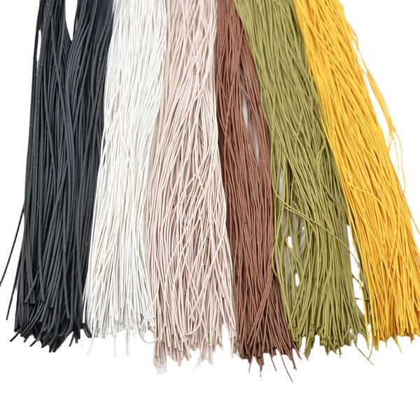 several colors of solid colored rainys round rubber legs for fly tying on white backgr