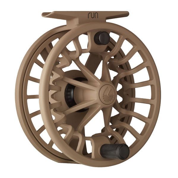 Coyote tan color Redington Run Fly Reel showing the handle side on a white background.