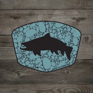 A Rep Your Water River Rock Trout Sticker, featuring a trout silhouette over river rock in blue, on a wood grain background.