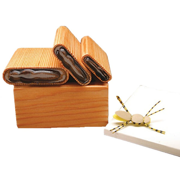 A selection of several sizes of River Road Creations Beavertail Foam Body Cutters, shown with the cutting pad and an example Foam Dry Fly, against a white background. 