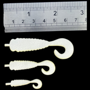 Semperfli ABC Universal Grub Bodies and Wiggle Tails for fly tying with ruler for measurement on a black background.