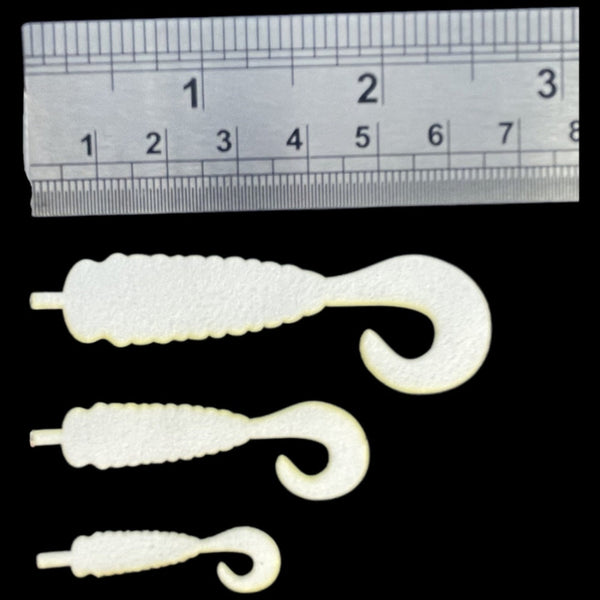 Semperfli ABC Universal Grub Bodies and Wiggle Tails for fly tying with ruler for measurement on a black background.