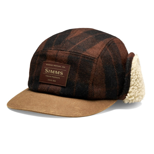 A Simms Coldweather Cap with a brown hickory duke plaid pattern, light brown visor, and cream sherpa ear flaps, shown against a white background.