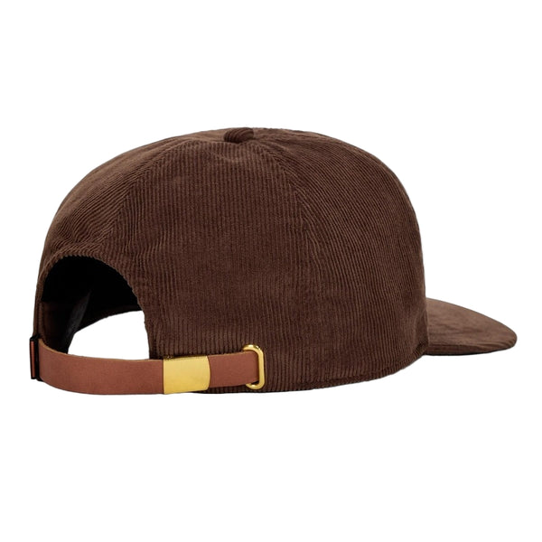 Brown corduroy cap with brown leather strap and gold buckle on a white background.