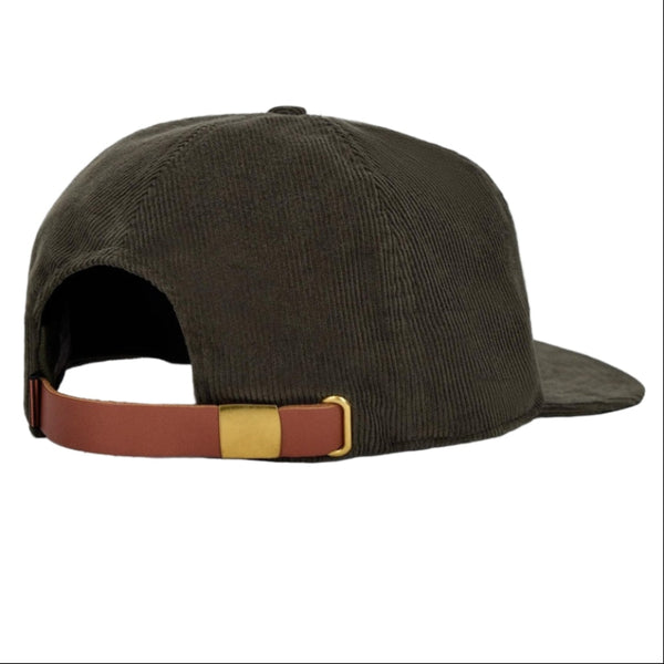 Brown corduroy cap with brown leather strap and gold buckle on a white background.