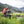 Man with an orange Simms Dry Creek Rolltop Backpack fishing in a mountainous area.