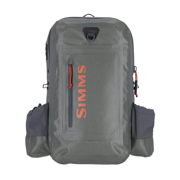 Olive and grey Simms Dry Creek Z Waterproof Backpack, showing the Simms logo, front zip pocket, waterproof zippers, and net attachment point, against a white background.