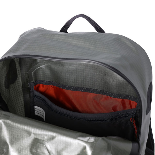 Interior of the olive and grey Simms Dry Creek Z Waterproof Backpack, showing the inside drop and zip pockets through the open waterproof zipper, against a white background.