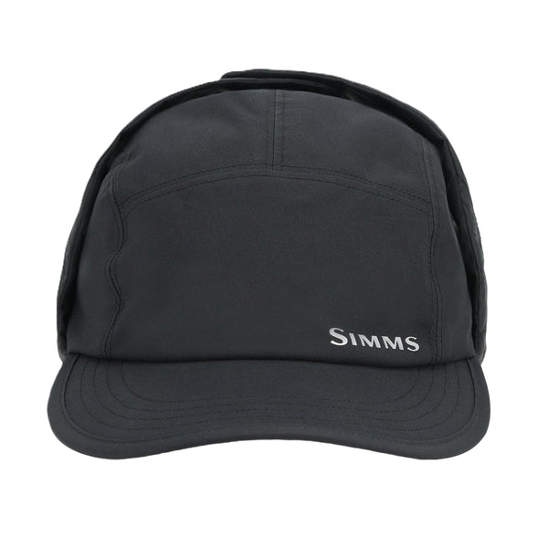 Black waterproof Simms ExStream Cap with ear flaps on a white background.