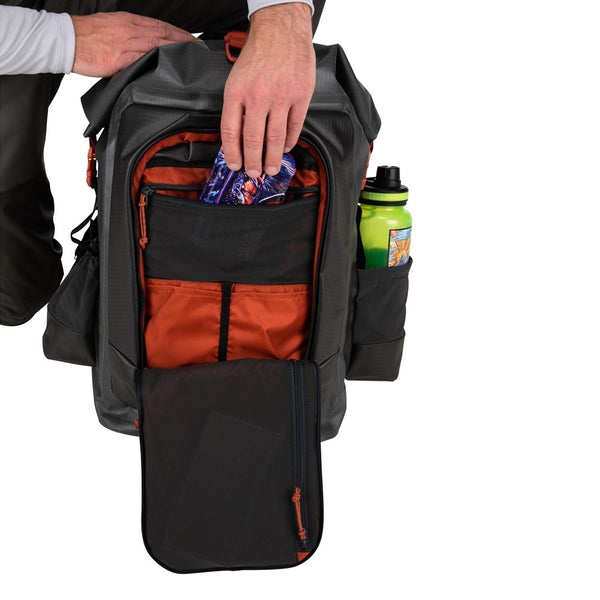 Interior view of the grey Simms G3 Guide Rolltop Backpack showing how accessories can fit inside on a white background.
