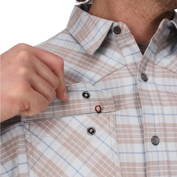 Person wearing the Simms Men's Brackett Flannel Shirt in sterling drummond plaid showing pocket details on a white background.