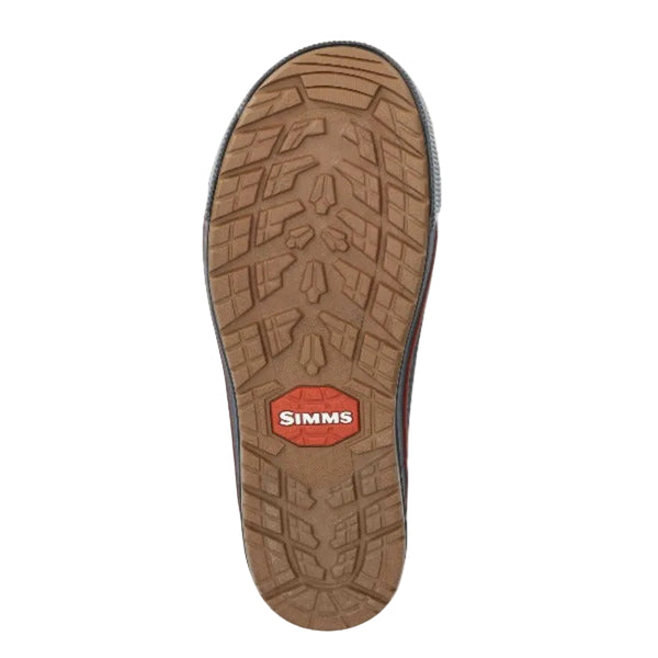 Vulcanized rubber sole of the Storm Grey Men's Simms Challenger 7-inch rubber boot with orange accents on a white background.