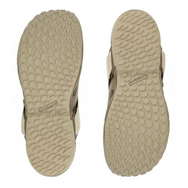Two dark stone brown and beige Simms Men's Drifter AT Fishing Shoe flipped over and showing the sole details on a white background.