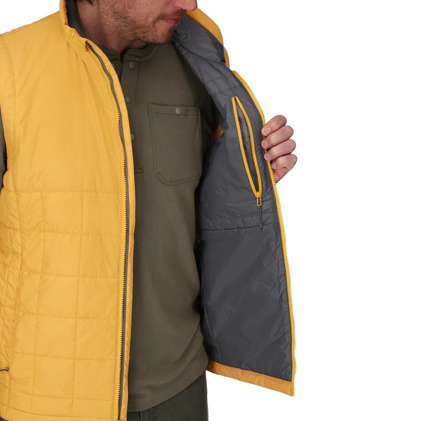 Man wearing a Baltic Amber Simms Men's Fall Run Insulated Vest showing interior pocket detail on a white background.