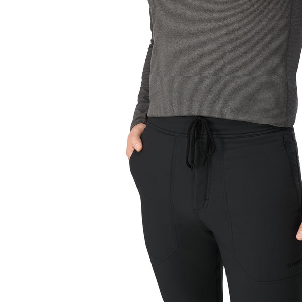 Person wearing the black Simms Men's Strata 330 Fleece Bottoms showing waist detail on a white background.