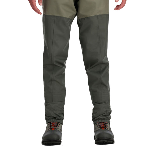 A person facing forward wearing Simms Men's Tributary Stockingfoot Waders zoomed in on the legs on a white background.