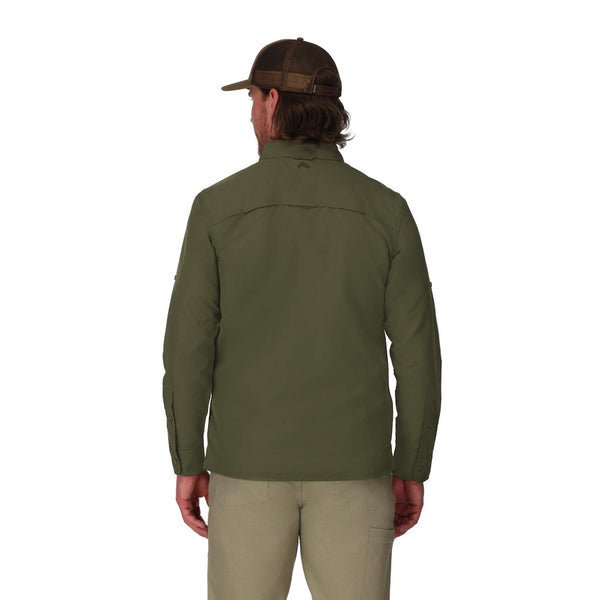 Back view of a man wearing long-sleeved loden green Simms men's UPF guide shirt with tan pants and a brown ball cap on a white background.