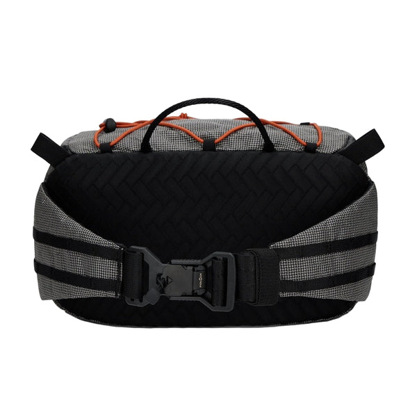 Black and gray Simms Scout Hip Pack bag with orange accents shown from the back on a white background.