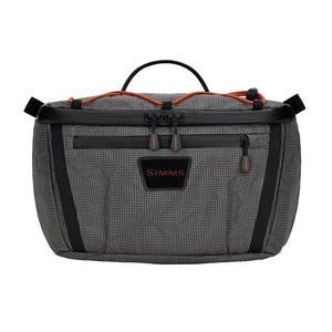 Black and gray Simms Scout Hip Pack bag with orange accents shown from the front on a white background.