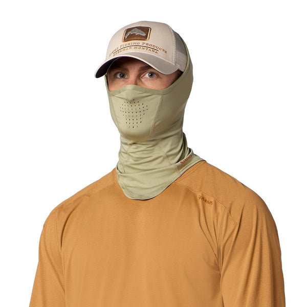A person wearing a tan ball cap, earthenware brown sun shirt, and the Simms SolarFlex UPF 50+ SunGaiter in pale pine green covering neck, face and head on a white background.