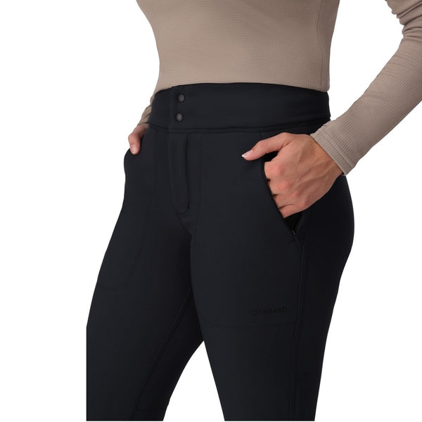 Person wearing the black Simms Women's Strata 330 Fleece Bottoms showing pocket detail on a white background.
