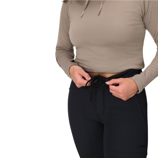 Person wearing the black Simms Women's Strata 330 Fleece Bottoms showing waist detail on a white background.