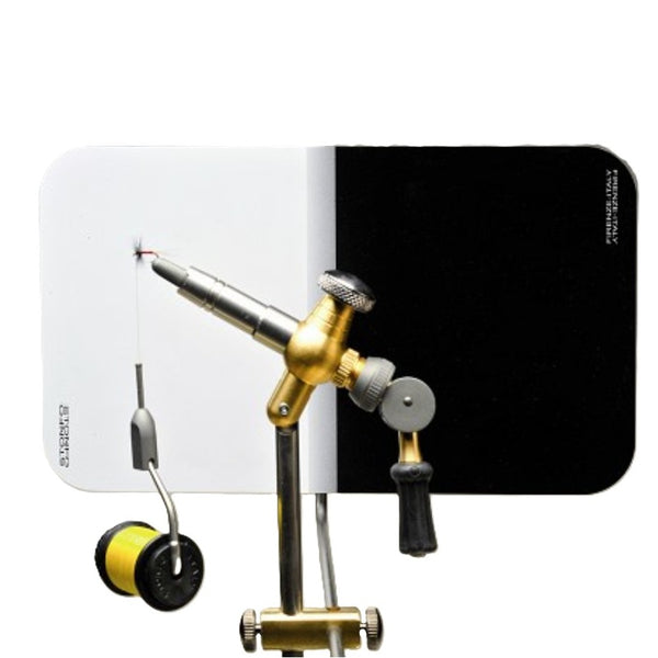 A Stonfo profile plate for fly tying, with a black and white color scheme, mounted behind a fly tying vise over a white background.
