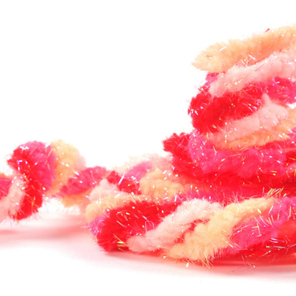 Twisted skeins of Textreme Pearl Eggstasy Fly Tying Egg Yarn in shades of pink, on a while background.