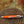 A Ty-Rite EZ Ty Hook Holder, model Junior, placed on a wooden surface with a blurred background.