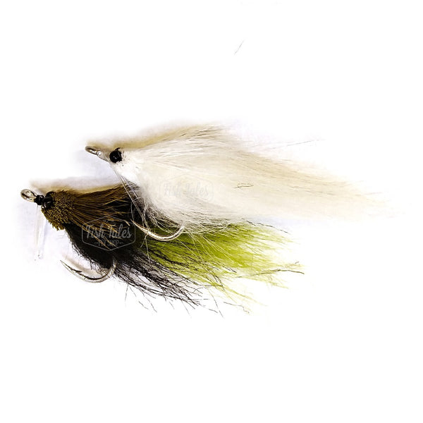 A pair of Umpqua Fishalicious Streamers, one white one and one green and black one, on a white background.