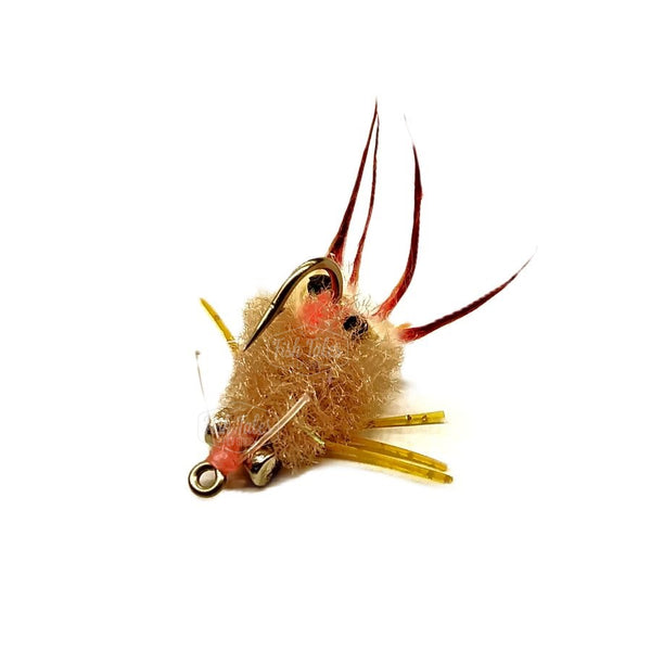 A Kung Fu Crab Saltwater Flats fly with a tan fiber wedge-shaped body, heavy lead eyes, rabbit strip claws, and rubber legs on a white background.
