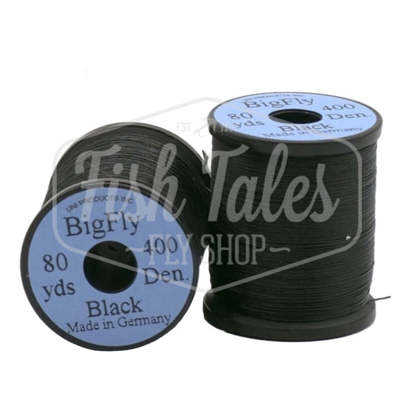 Two spools of black UNI Big Fly fly tying thread on a white background.