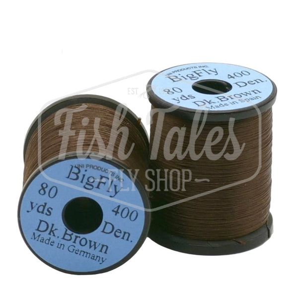 Two spools of dark brown UNI Big Fly fly tying thread on a white background.