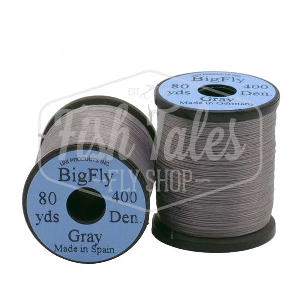Two spools of grey UNI Big Fly fly tying thread on a white background.