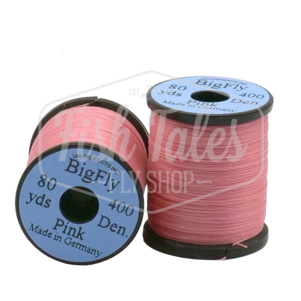 Two spools of pink UNI Big Fly fly tying thread on a white background.