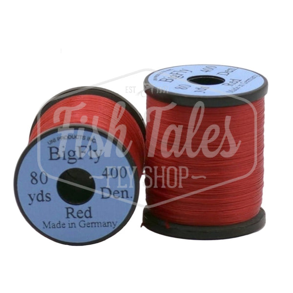 Two spools of red UNI Big Fly fly tying thread on a white background.