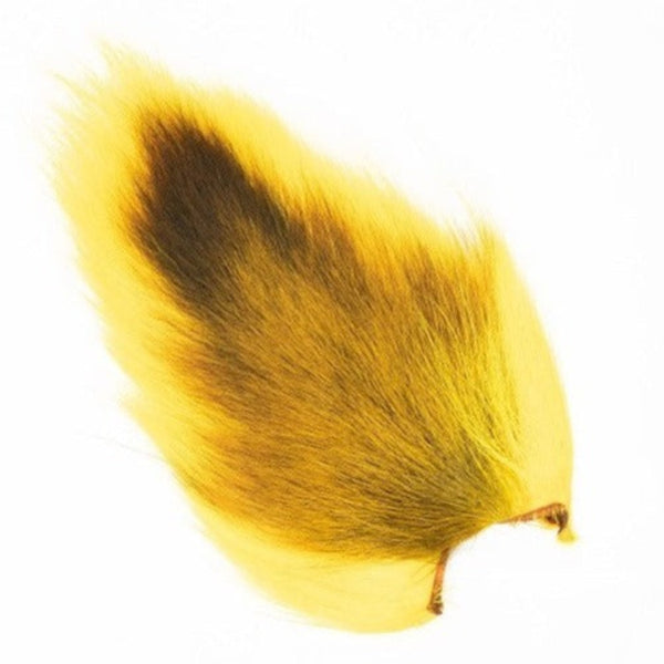 A dyed fluorescent yellow Veniard Doe Tail for fly tying on a white background.